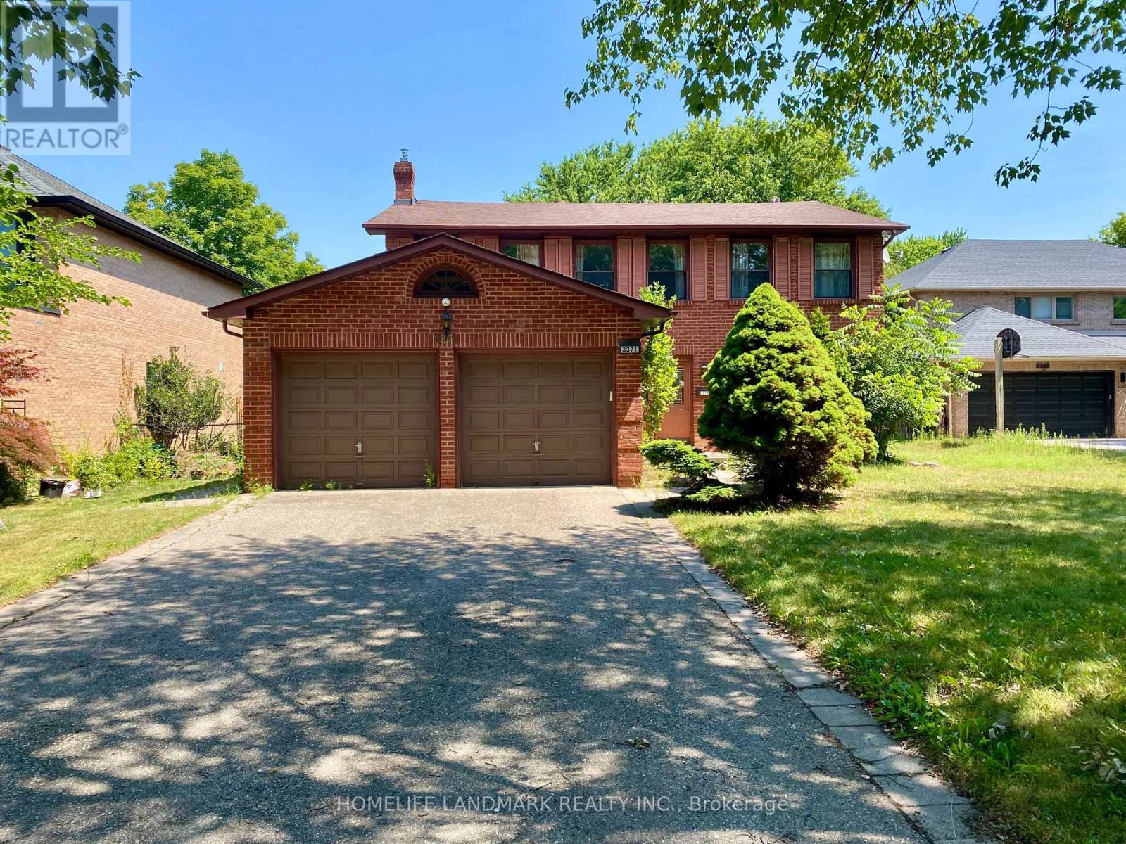 A brick house with a garage door in the front.