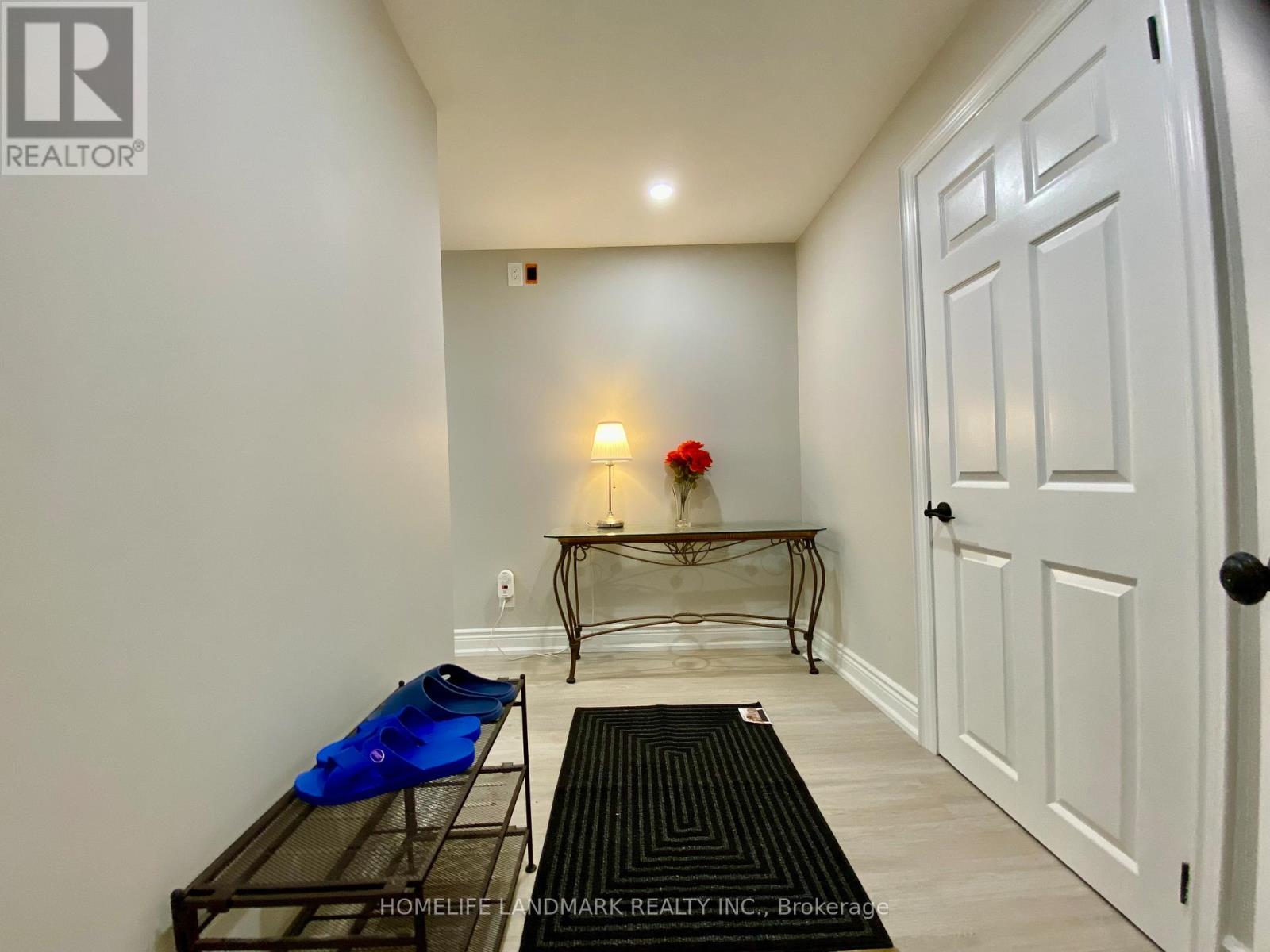 A hallway with a bench and a door.