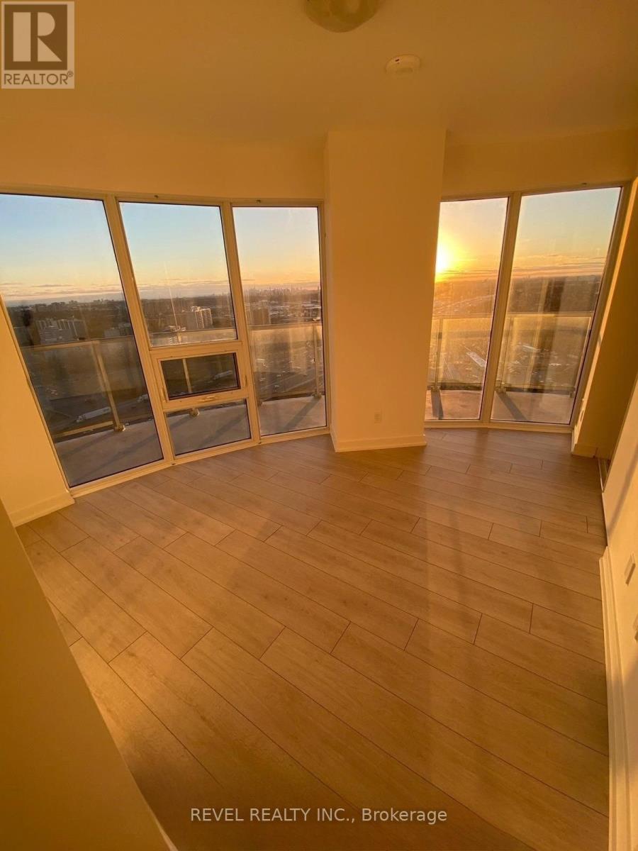 A sunny room with a view of the cityscape at sunset.