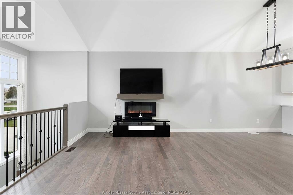 A living room with a television and a fireplace.