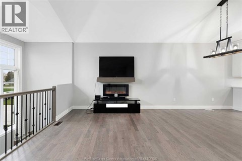 A living room with a television and a fireplace.