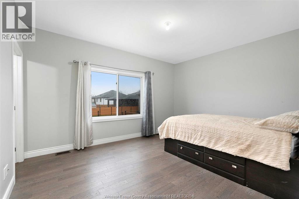 A bedroom with a large bed and a window overlooking a mountain.