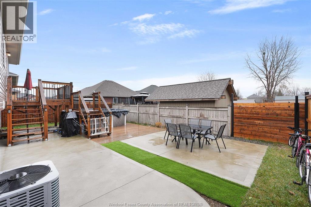 A backyard with a patio, a hot tub, and a bicycle.