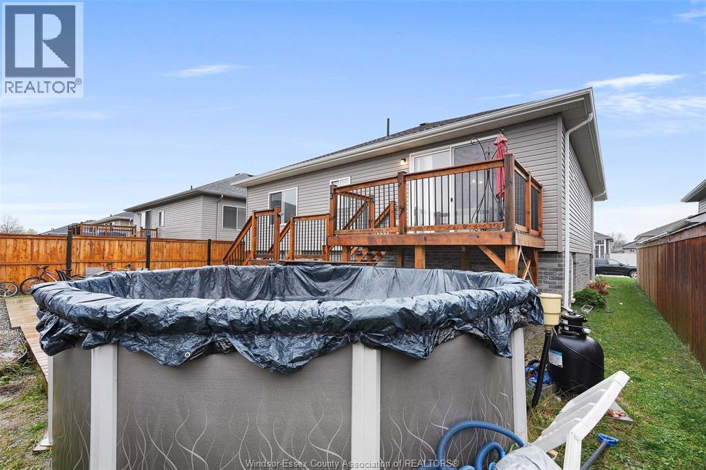 A backyard with a pool covered in a tarp.