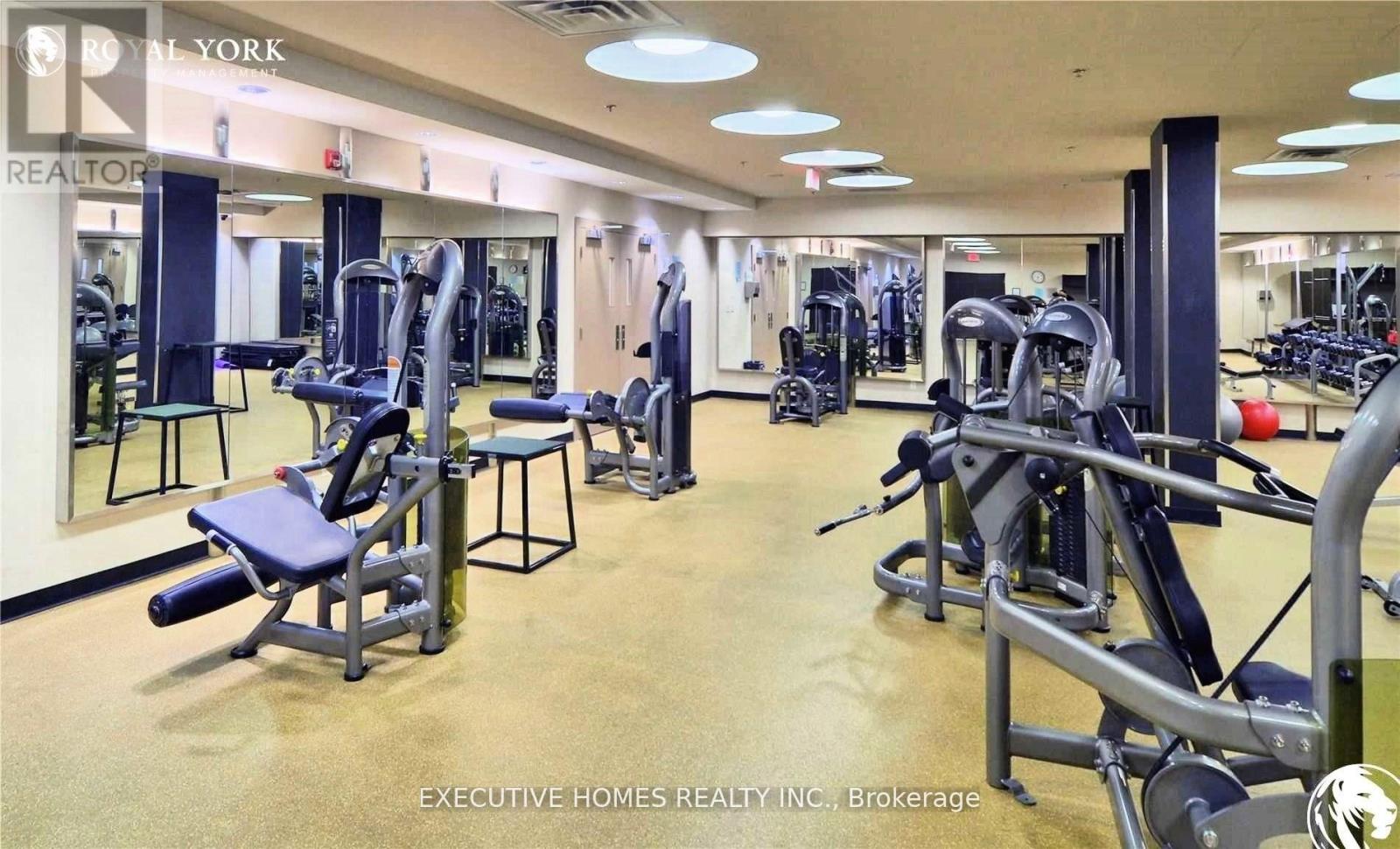 A gym with a variety of equipment including weights and machines.