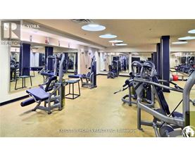 A gym with a variety of equipment including weights and machines.