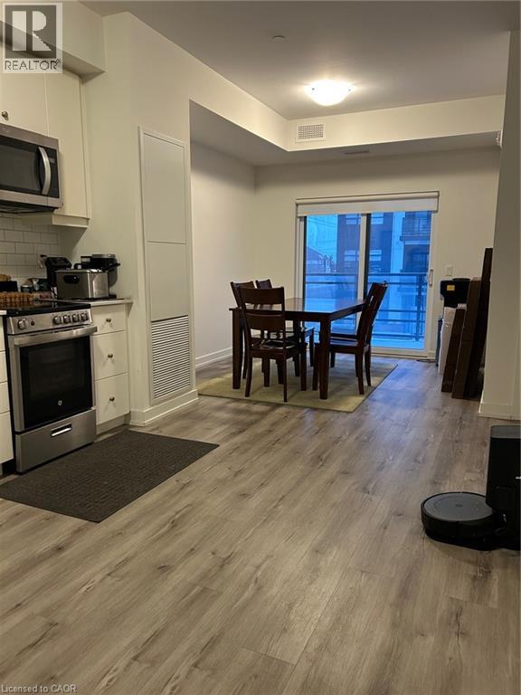 A kitchen with a dining table and chairs.