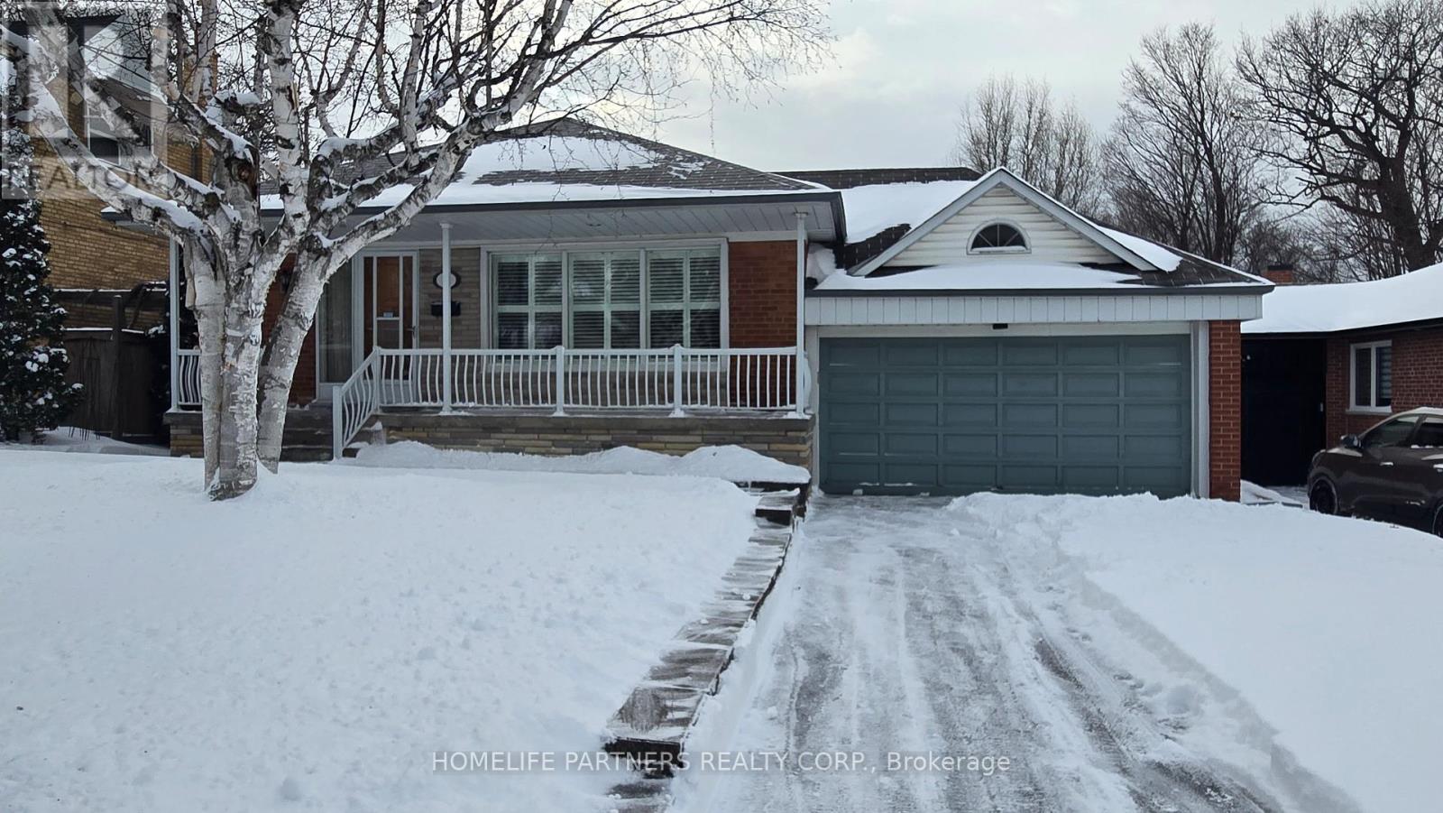 A house with a garage and a driveway covered in snow.