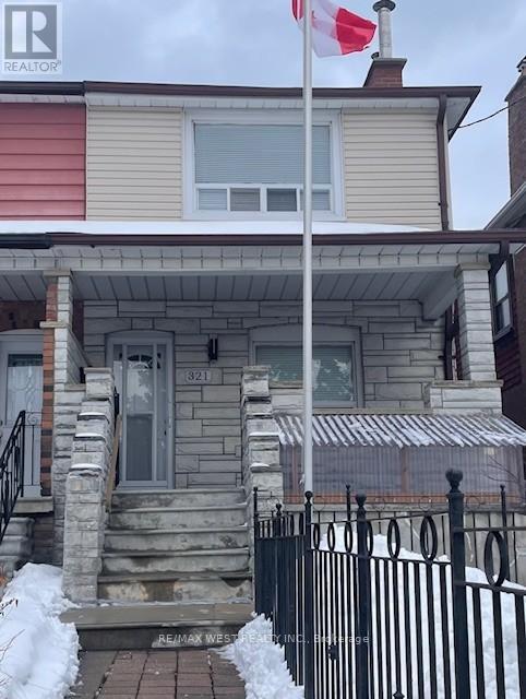 A house with a Canadian flag on a pole in front.