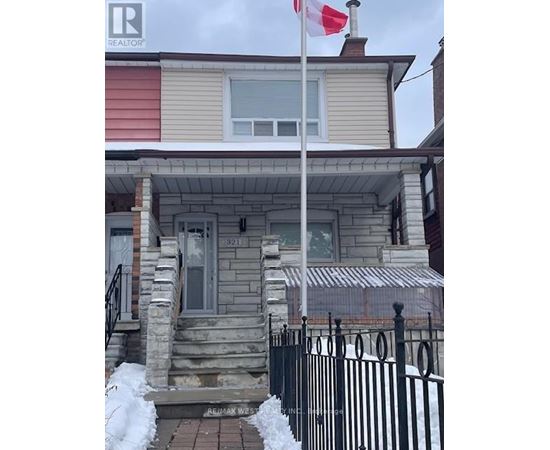 A house with a Canadian flag on a pole in front.