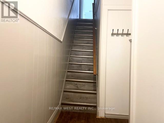 A staircase with a white door on the side.