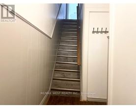 A staircase with a white door on the side.