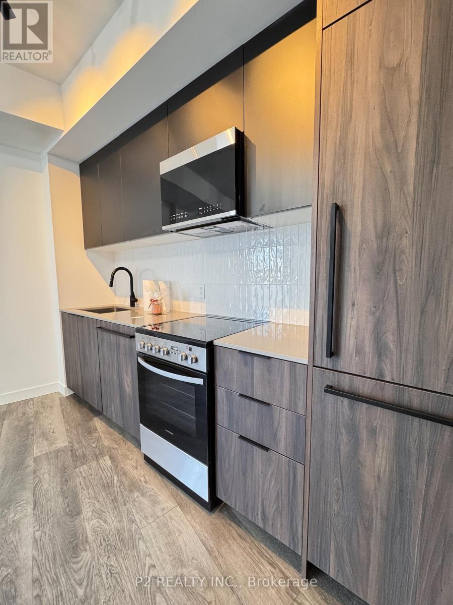 A modern kitchen with a stainless steel oven and microwave.