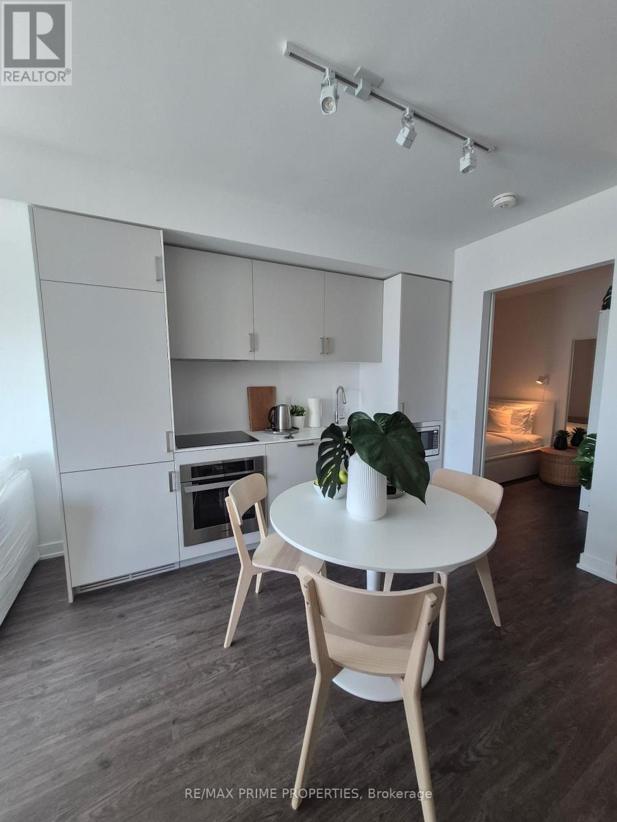 A dining area with a table and chairs in a modern kitchen.
