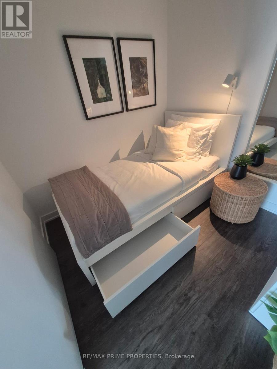 A bedroom with a bed and a wicker basket on the floor.