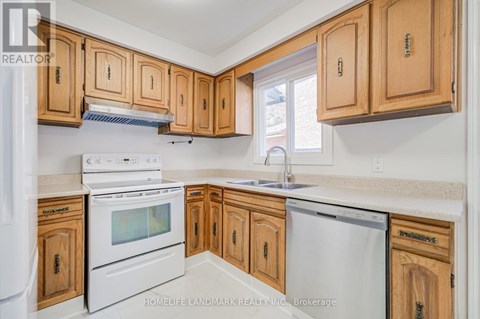 A kitchen with wooden cabinets and white appliances.