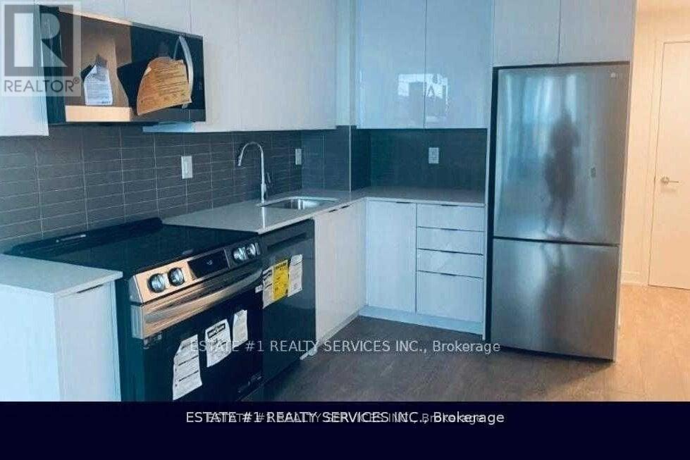 A kitchen with a black stove top oven and a black refrigerator.
