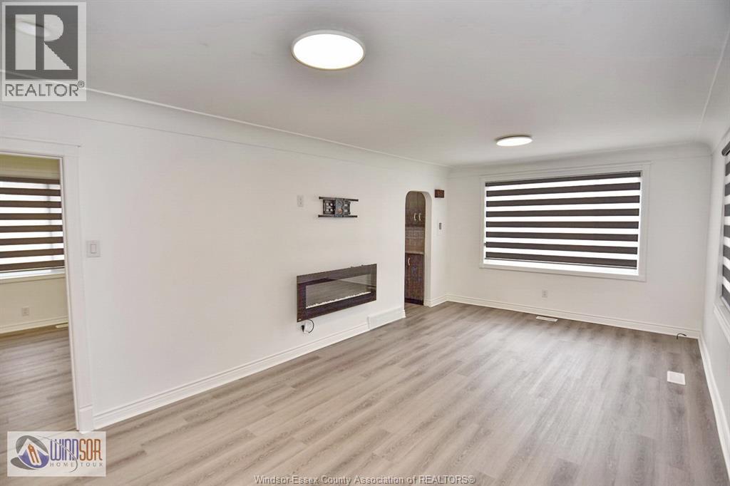 A spacious living room with a fireplace and a television.
