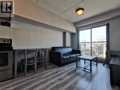 A living room with a black couch and a coffee table.