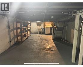 A large, empty warehouse space with a concrete floor and walls.