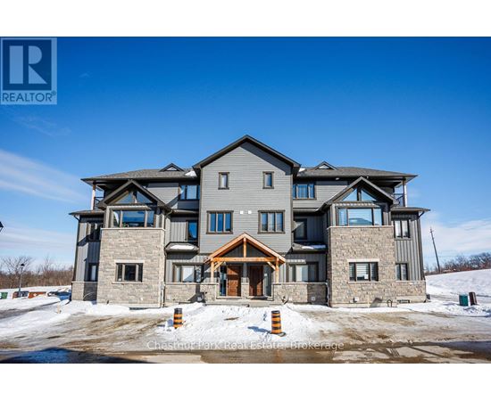 A large, modern house with a stone facade and a large front porch.