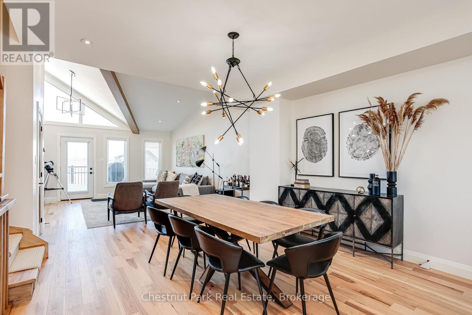 A dining room with a wooden table and chairs.