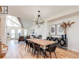 A dining room with a wooden table and chairs.