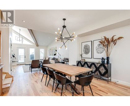 A dining room with a wooden table and chairs.