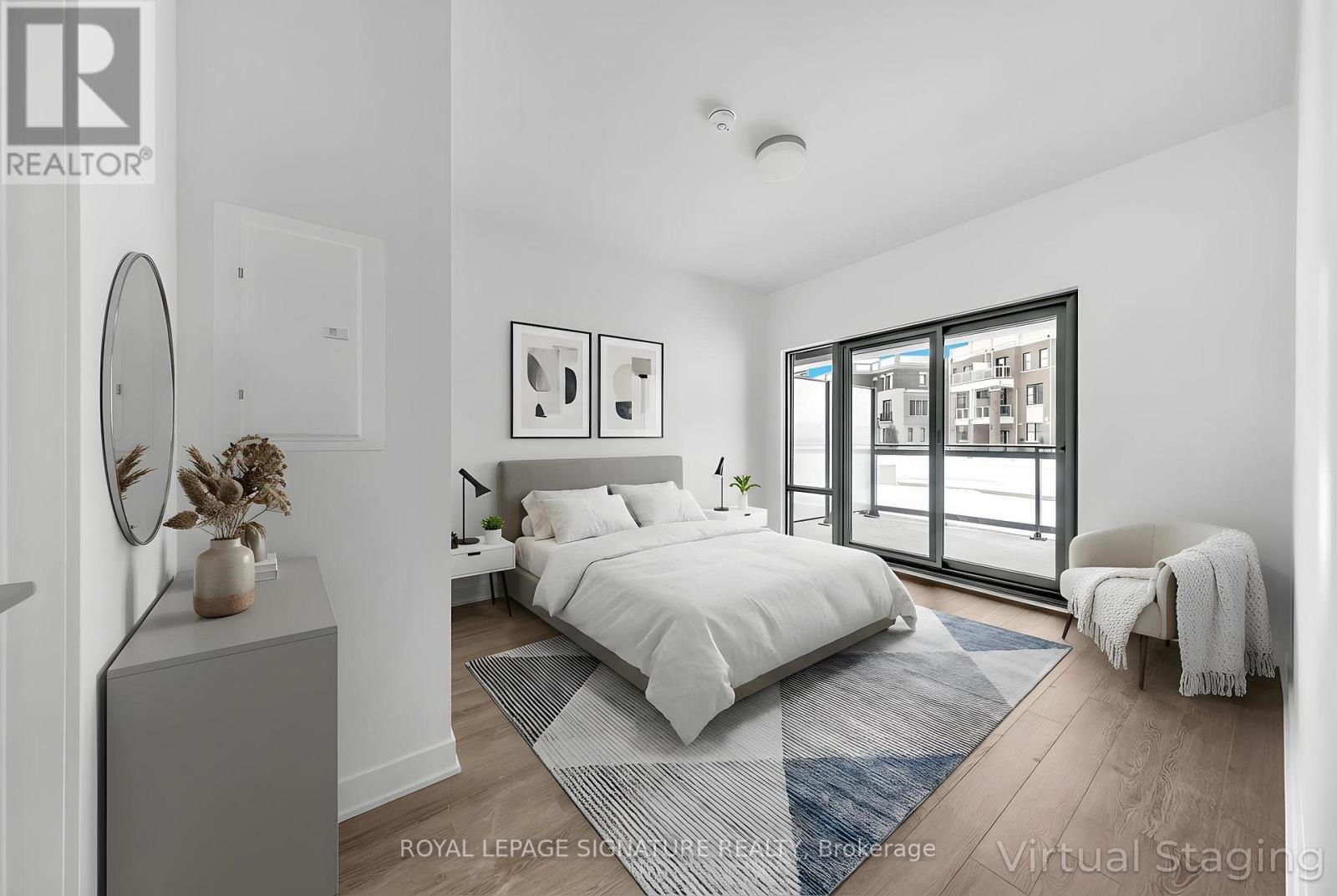 A bedroom with a large bed, a chair, and a window with a view of a building.