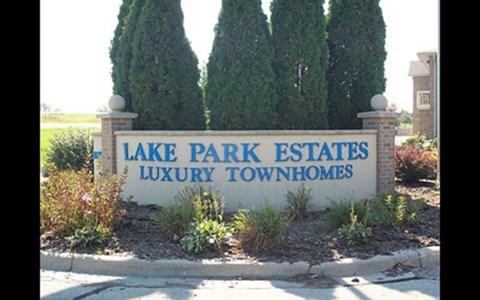 A sign that says Lake Park Estates Luxury Townhomes.
