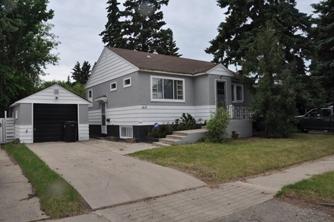 A house with a garage and a driveway.