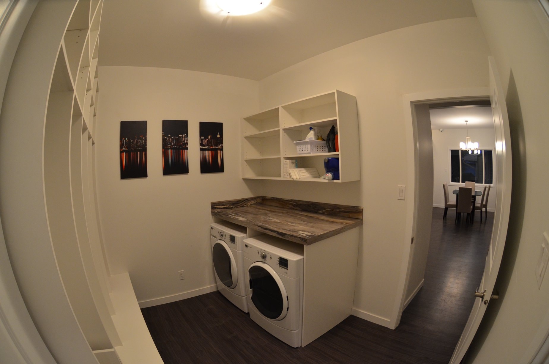 A laundry room with a washer and dryer and a counter top.
