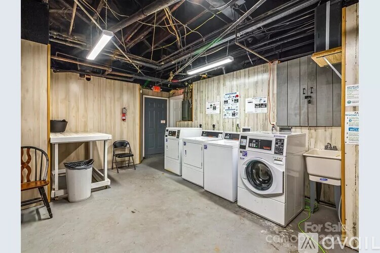 A laundry room with washers and dryers for sale.
