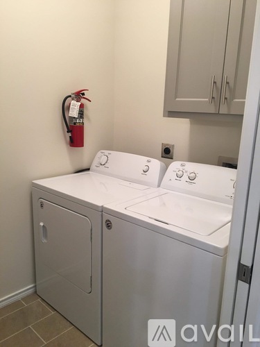 A white washing machine and dryer in a small laundry room.