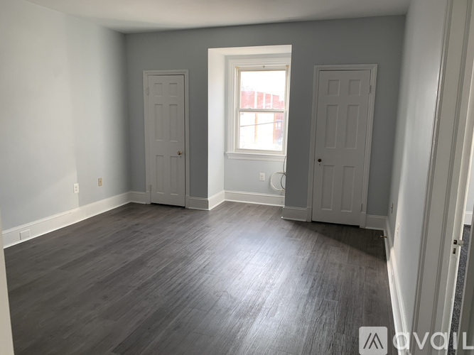 A room with two doors and a window.
