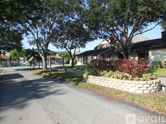 A street view of a residential area with houses and trees.