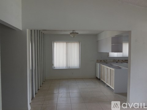 A kitchen area with a window and a sink.