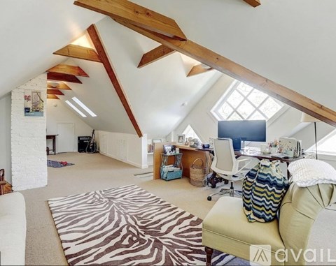 A living room with a zebra rug and a couch.