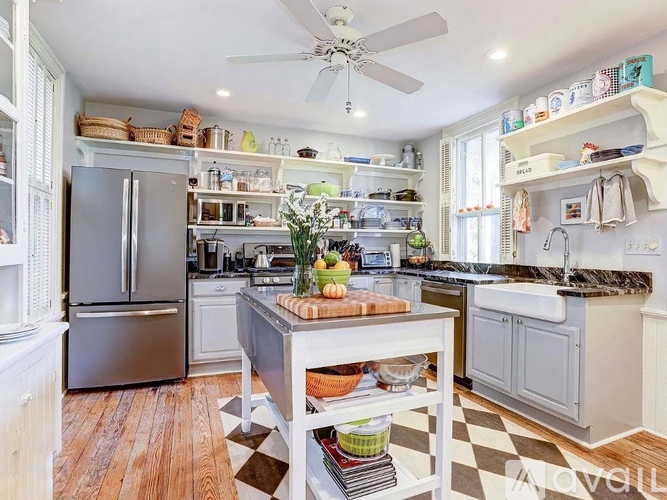 A kitchen with a black and white checkered floor.
