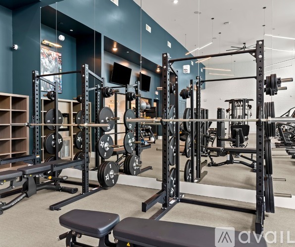 A gym with a variety of weightlifting equipment.