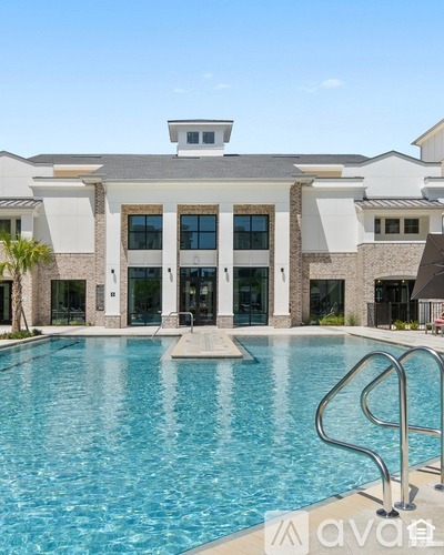 A modern house with a swimming pool in front.
