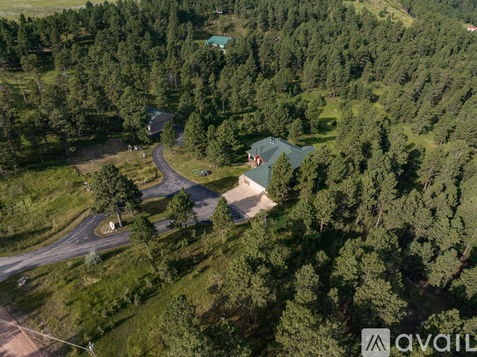 A bird's eye view of a house surrounded by trees.