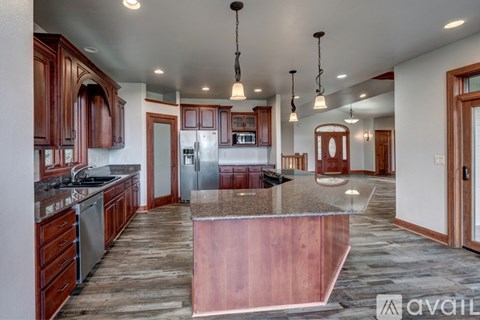 A kitchen with wooden cabinets and a central island.