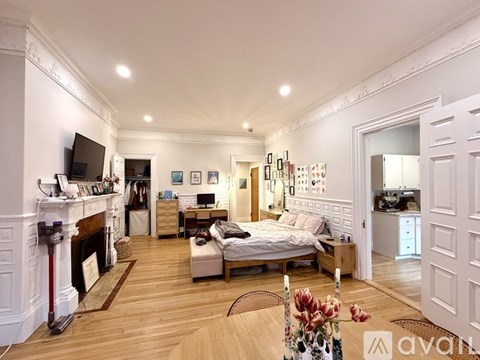 A kitchen with white cabinets and a stainless steel refrigerator.