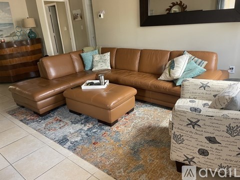 A bedroom with a bed, a chair, and a ceiling fan.