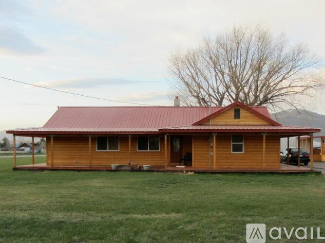 A house with a red roof and wooden exterior is available for purchase.
