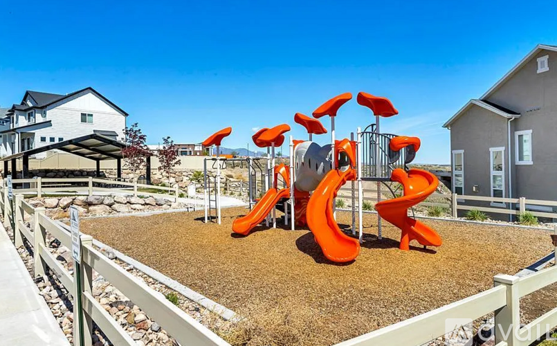 A playground with a slide and a climbing structure.