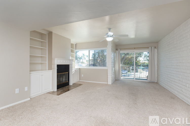 A spacious living room with a fireplace and sliding glass doors.