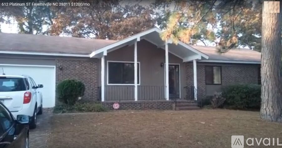 A house with a car parked in front of it.