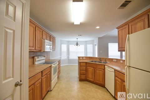 A kitchen with wooden cabinets and a white refrigerator.